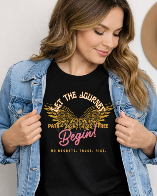 Woman wearing a jean jacket and black t-shirt with motivational quote and with wings, standing against a plain background.